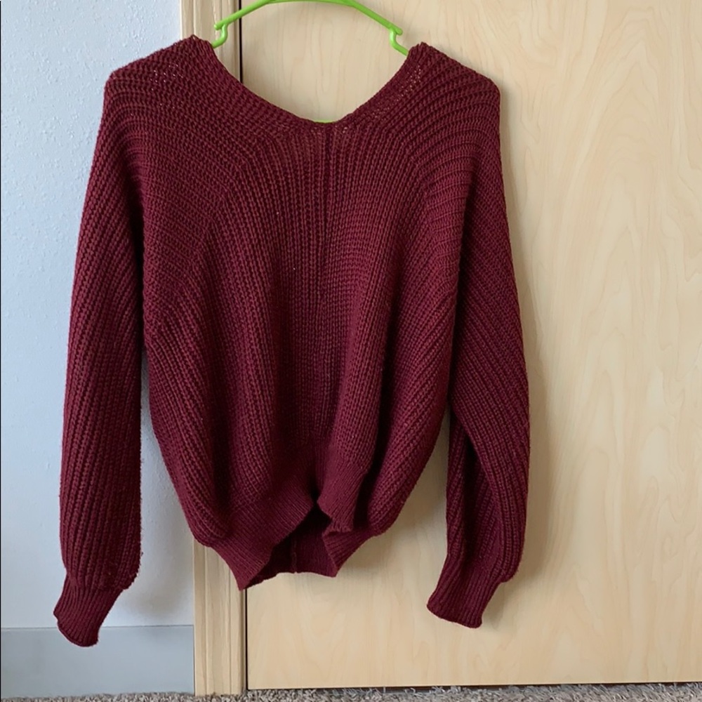 Hip length, knit, sweater with cross back